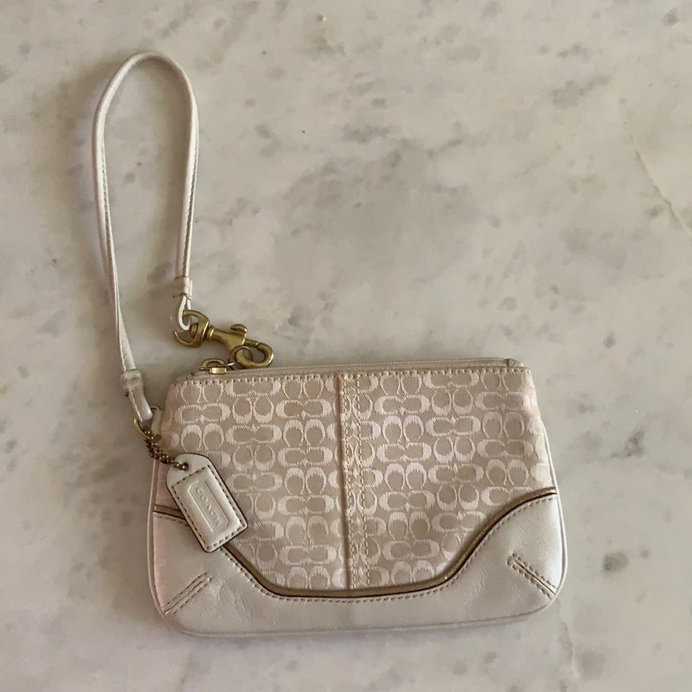 Signature wristlet with white leather.